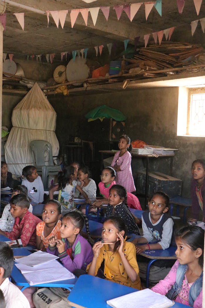 A group of children attentively learning in a rural classroom in Banaskantha, India.
