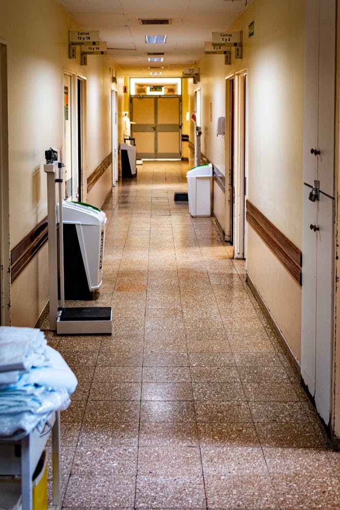 A quiet, empty hospital corridor with medical equipment and a scale.
